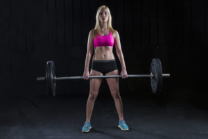 A female college student lifts weights