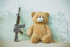Teddy bear with toy gun