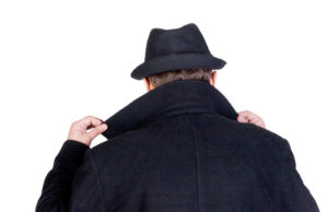 Mysterious man hiding his face behind a raised collar